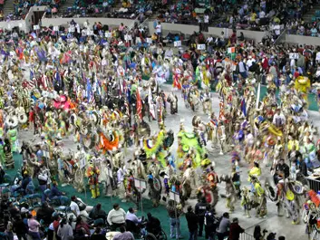 close up of honor guard surrounded by dancers from different regions