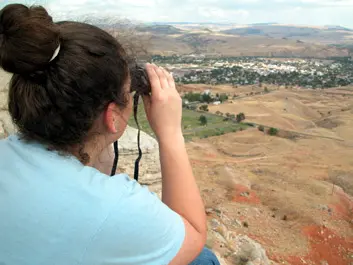 Amanda looks through binoculars on top of Roundtop