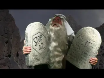 Is Nothing Sacred - Moses holds stone tablets while talking to God.