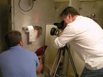 Jim Phelan and the crew film toilet paper on the side of a bathroom stall.